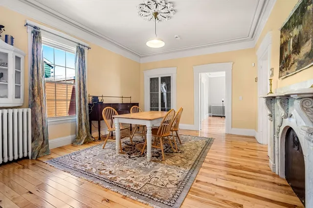 a dining room with furniture a rug and wooden floor