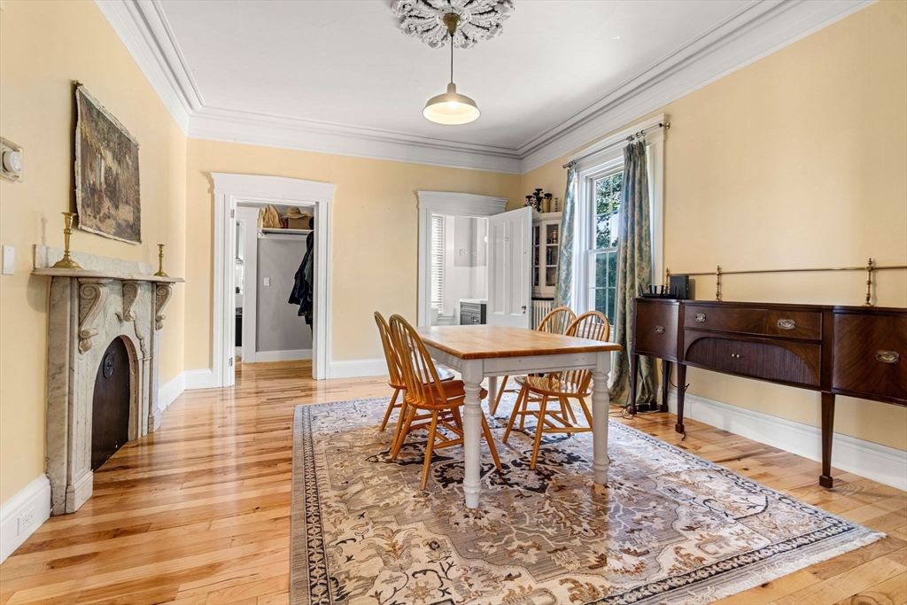 33 Middle Street Gloucester, MA 01930 - Photo 16 of 42 a dining room with furniture a rug and wooden floor