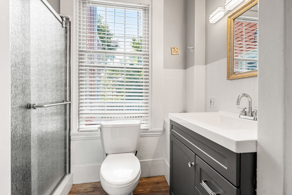 33 Middle Street Gloucester, MA 01930 - Photo 17 of 42 a bathroom with a toilet a sink a vanity and mirror
