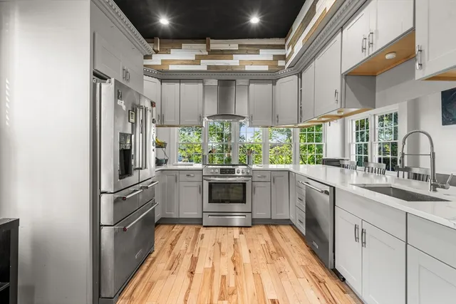 a kitchen with stainless steel appliances granite countertop a stove and a sink