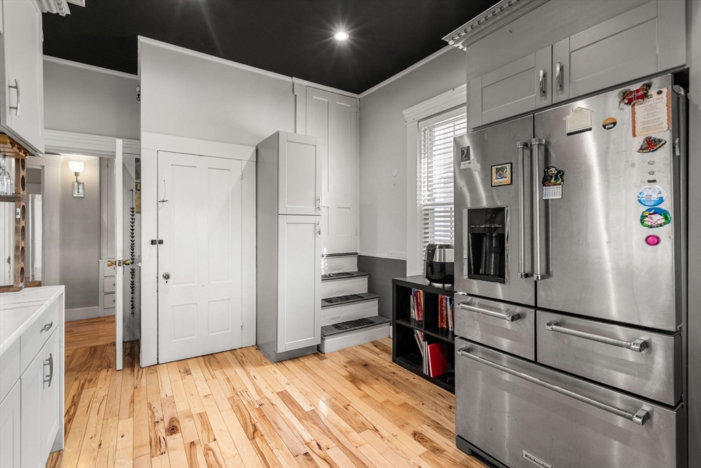 33 Middle Street Gloucester, MA 01930 - Photo 22 of 42 a kitchen with stainless steel appliances a refrigerator and wooden floor