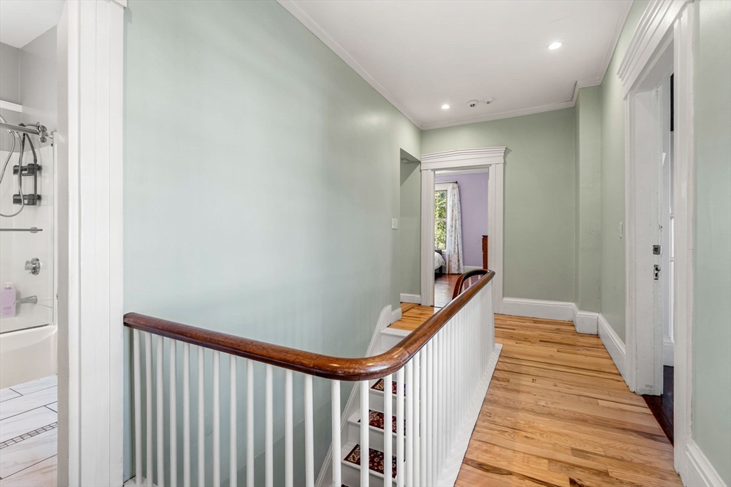 33 Middle Street Gloucester, MA 01930 - Photo 24 of 42 a view of a hallway with wooden floor and stairs