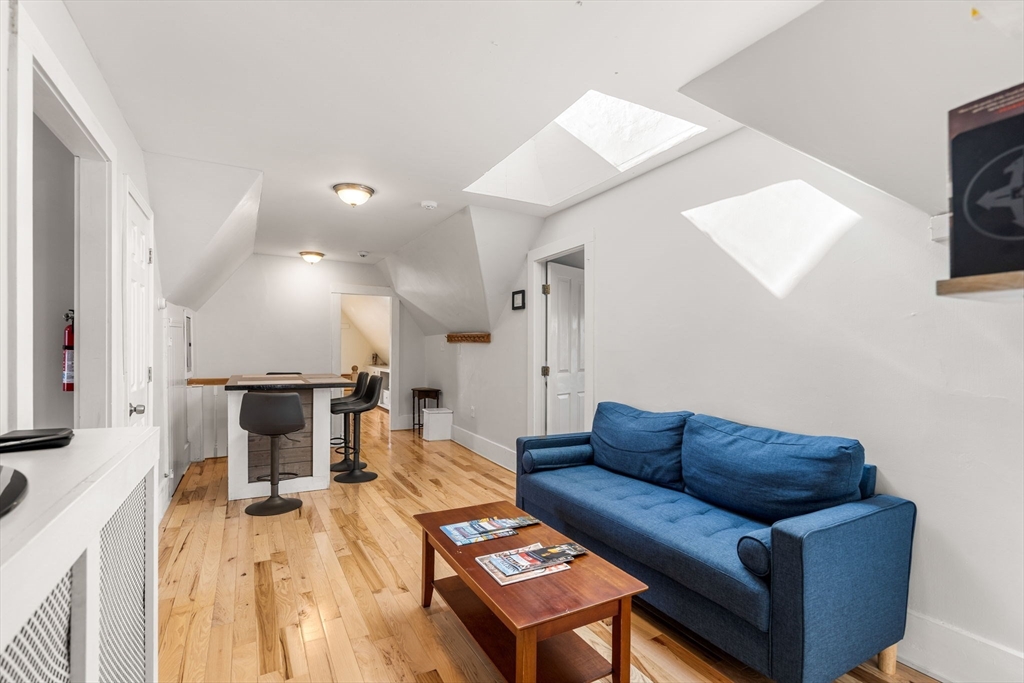 33 Middle Street Gloucester, MA 01930 - Photo 34 of 42 a living room with furniture and a wooden floor