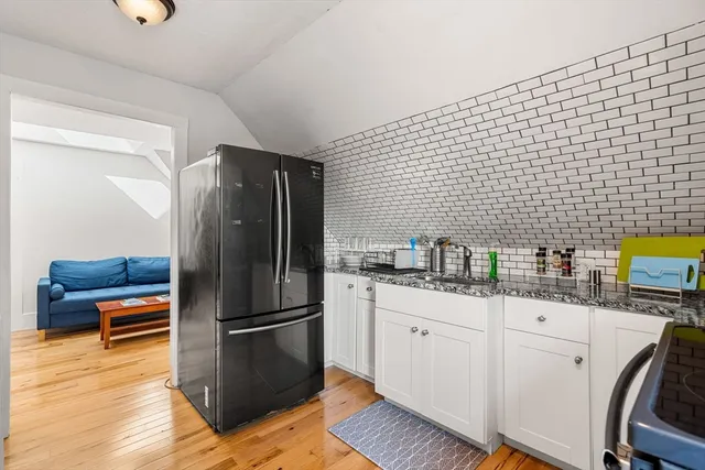 a bedroom with a bed and lamp on desk