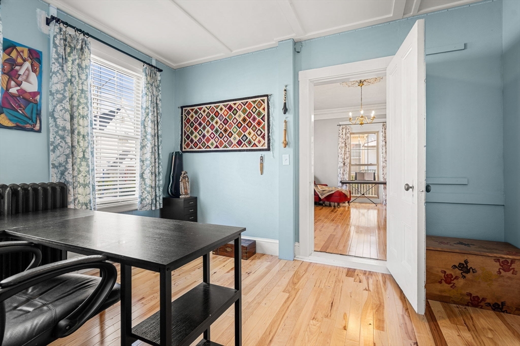 33 Middle Street Gloucester, MA 01930 - Photo 9 of 42 a bedroom with a bed and a table in it