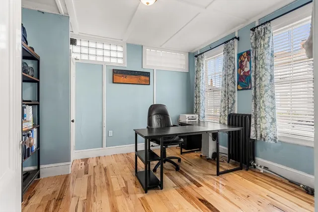a workspace with furniture window and wooden floor