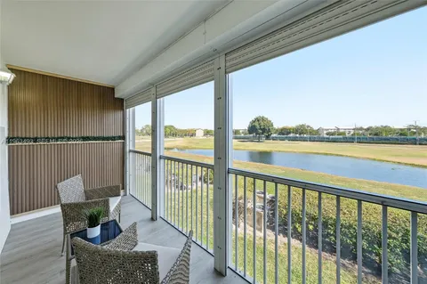 a view of a city from a balcony with furniture