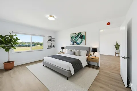 a bedroom with a bed and a potted plant