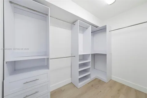 a view of walk in closet with empty racks