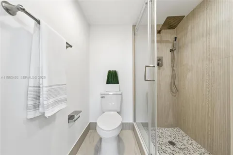 a bathroom with a toilet and a shower