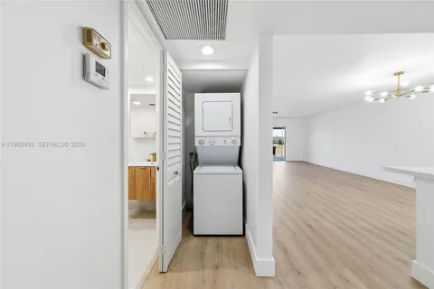a hallway with wooden floor and cabinet