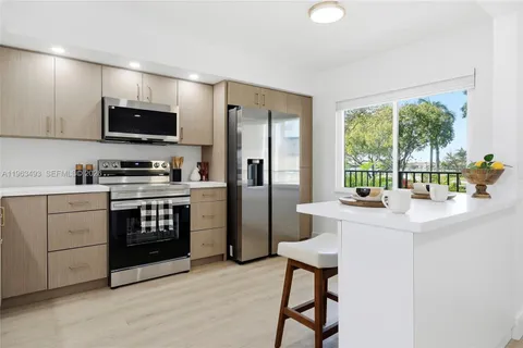 a kitchen with a stove a sink and a refrigerator