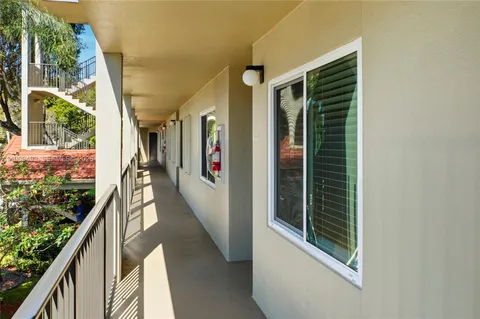 a view of a house with swimming pool yard and palm tree