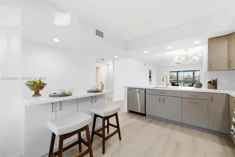 a kitchen with a sink cabinets and wooden floor