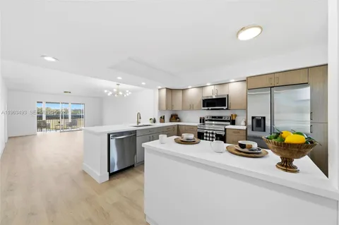 a kitchen with sink a stove and chairs
