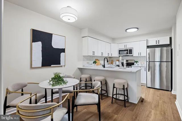 a kitchen with stainless steel appliances a refrigerator stove and microwave