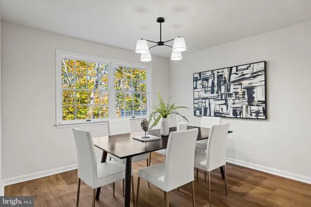 a living room with furniture a flat screen tv and a potted plant