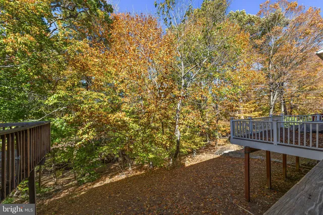 a bedroom with a bed and a flat tv screen on dresser