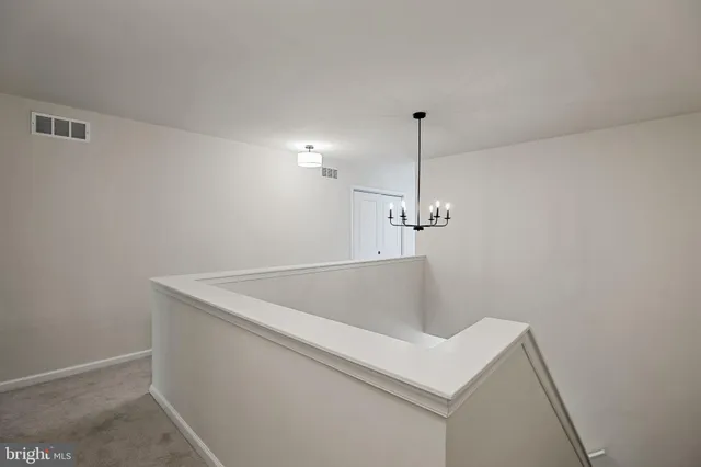 a bedroom with a bed and a flat tv screen on dresser