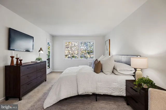 a bedroom with a bed and a lamp