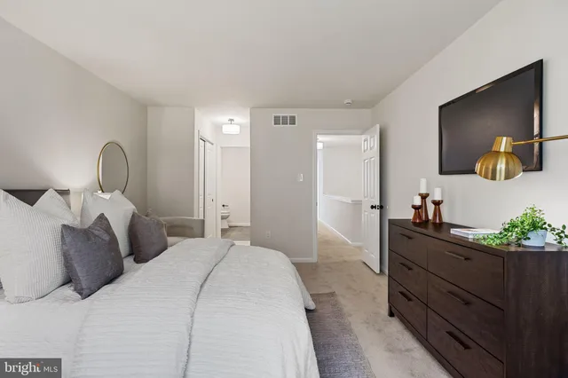 a bedroom with two beds and a window