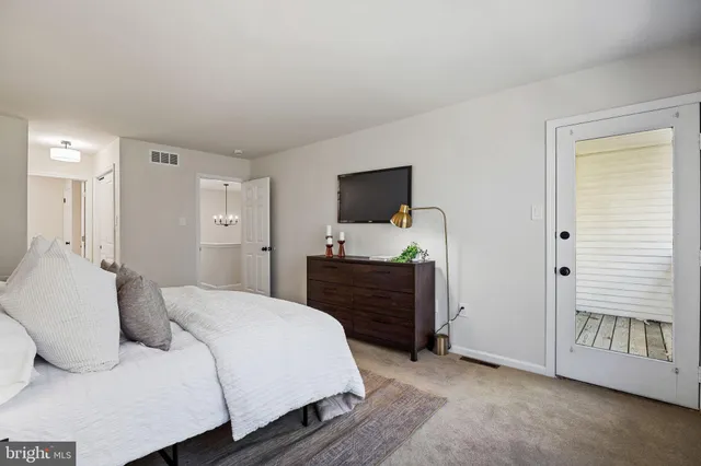 a bedroom with a bed and a painting on the wall