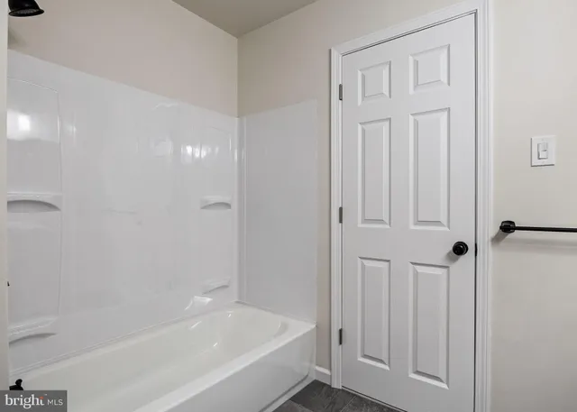 a bathroom with a toilet and a bath tub
