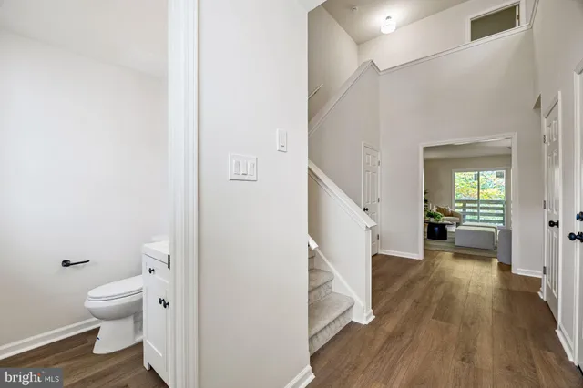 a view of a hallway with wooden floor and entryway