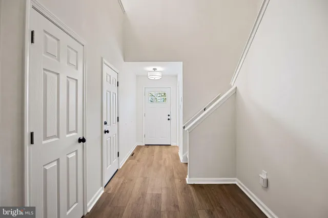 a kitchen with white cabinets and appliances