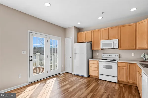 a kitchen with a stove a refrigerator and a sink