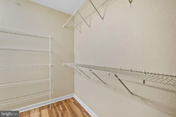 a view of walk in closet with empty racks