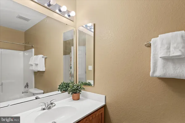 a bathroom with a sink vanity and mirror