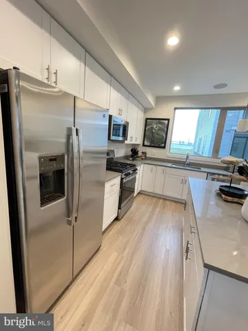 a kitchen with stainless steel appliances a refrigerator and a stove