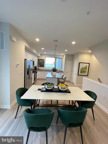 a kitchen with a table chairs stove and kitchen island
