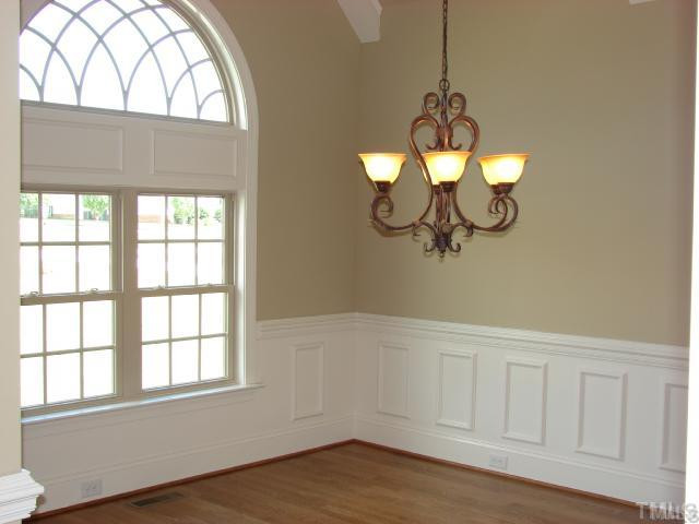 1137 Wakefield Farm Road Zebulon, NC 27597 - Photo 5 of 10 Vaulted Formal Dining with beams in ceiling, custom moldings, and wainscoting. Elegant hardwoods complete the formal look.