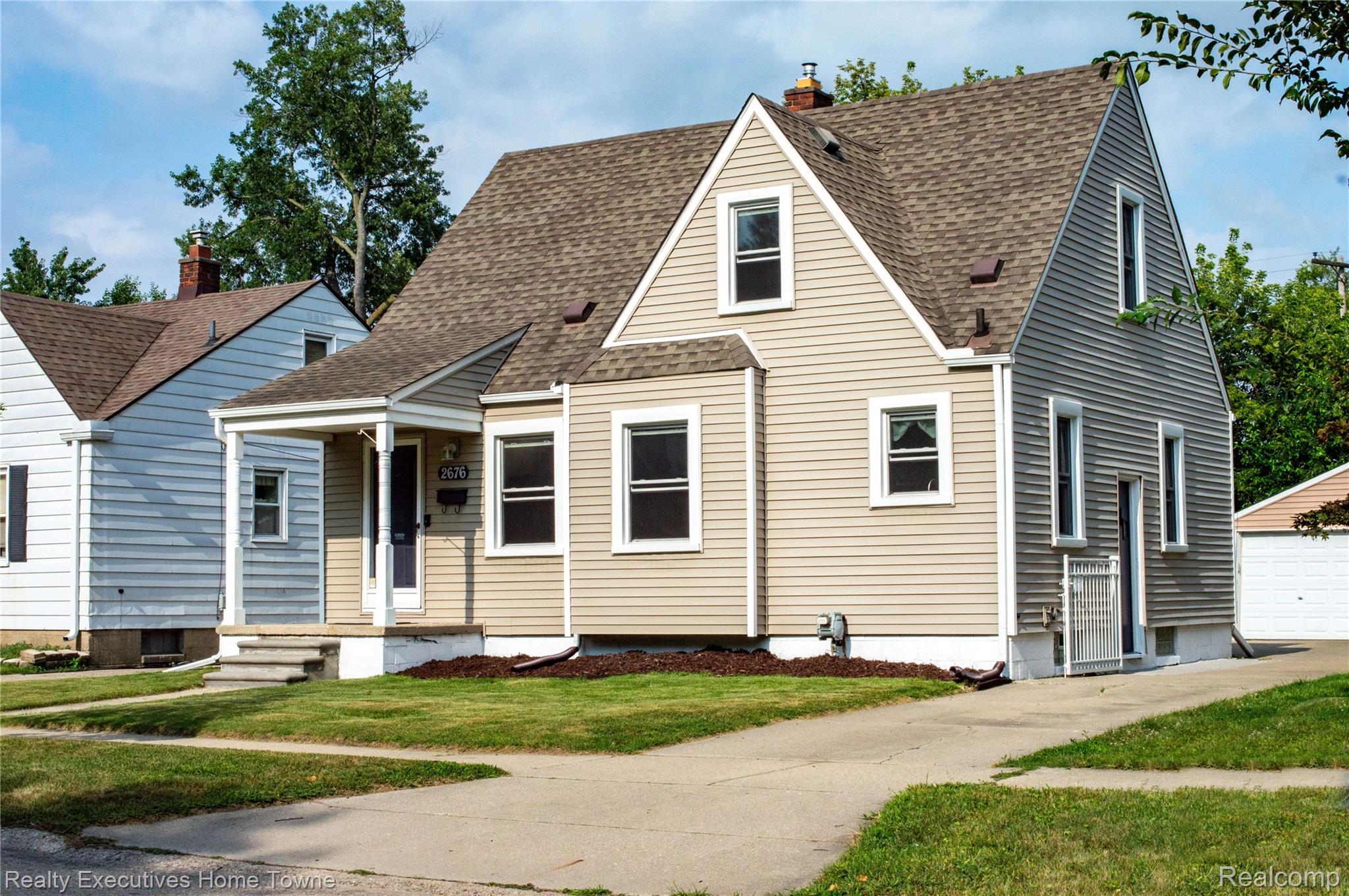 2676 Cumberland Road Berkley, MI 48072 - Photo 2 of 38 Gabled residence featuring light-colored siding, a covered porch with white columns, and a paved driveway