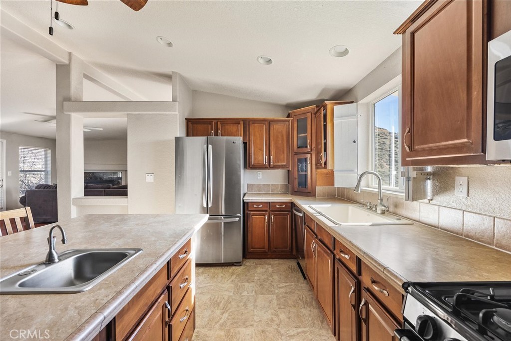 990 Mesa Valley Road Lebec, CA 93243 - Photo 12 of 38 a kitchen with stainless steel appliances granite countertop a sink stove and refrigerator