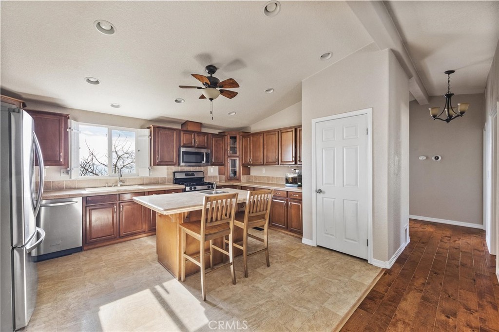 990 Mesa Valley Road Lebec, CA 93243 - Photo 13 of 38 a kitchen with a wooden floor and white stainless steel appliances