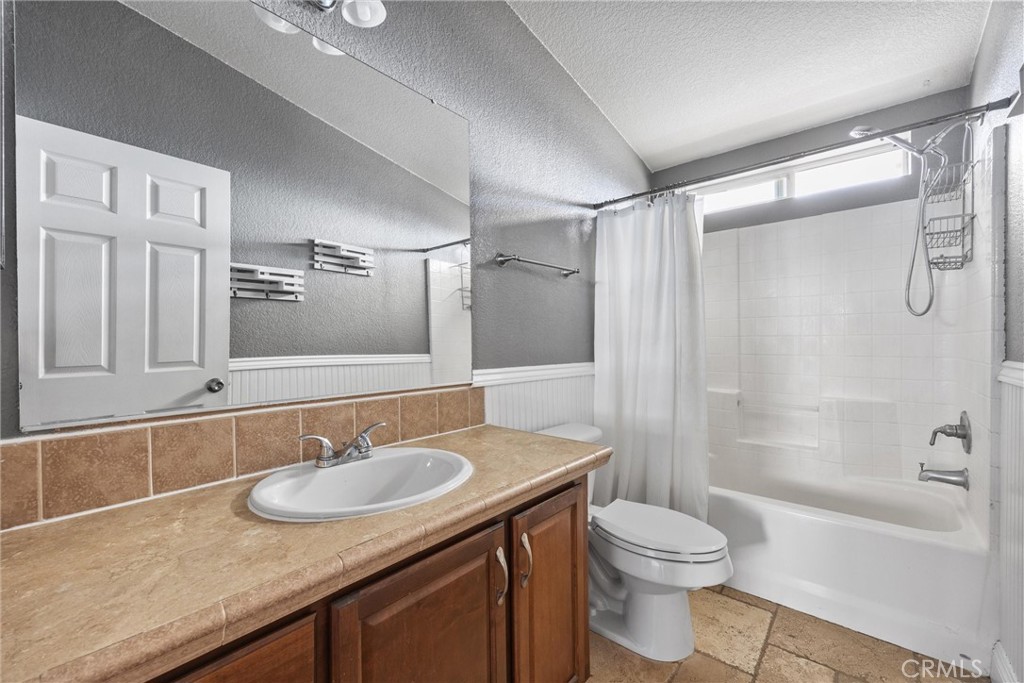 990 Mesa Valley Road Lebec, CA 93243 - Photo 20 of 38 a bathroom with a granite countertop sink toilet a mirror and shower
