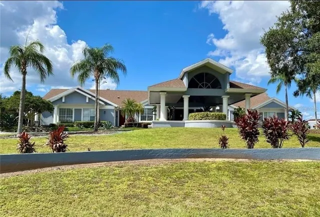 a front view of a house with swimming pool having outdoor seating