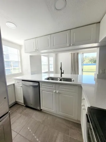a kitchen with appliances cabinets and a sink