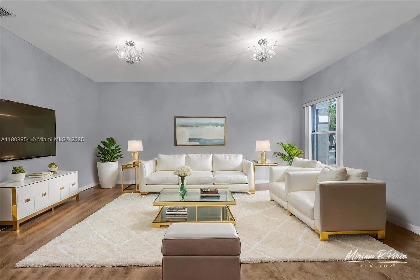 14059 Southwest 49th Street, Unit 4 Miramar, FL 33027 - Photo 1 of 29 a living room with furniture and a flat screen tv
