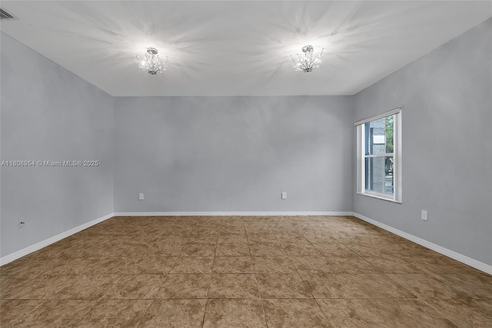 14059 Southwest 49th Street, Unit 4 Miramar, FL 33027 - Photo 12 of 29 a view of an empty room with a window