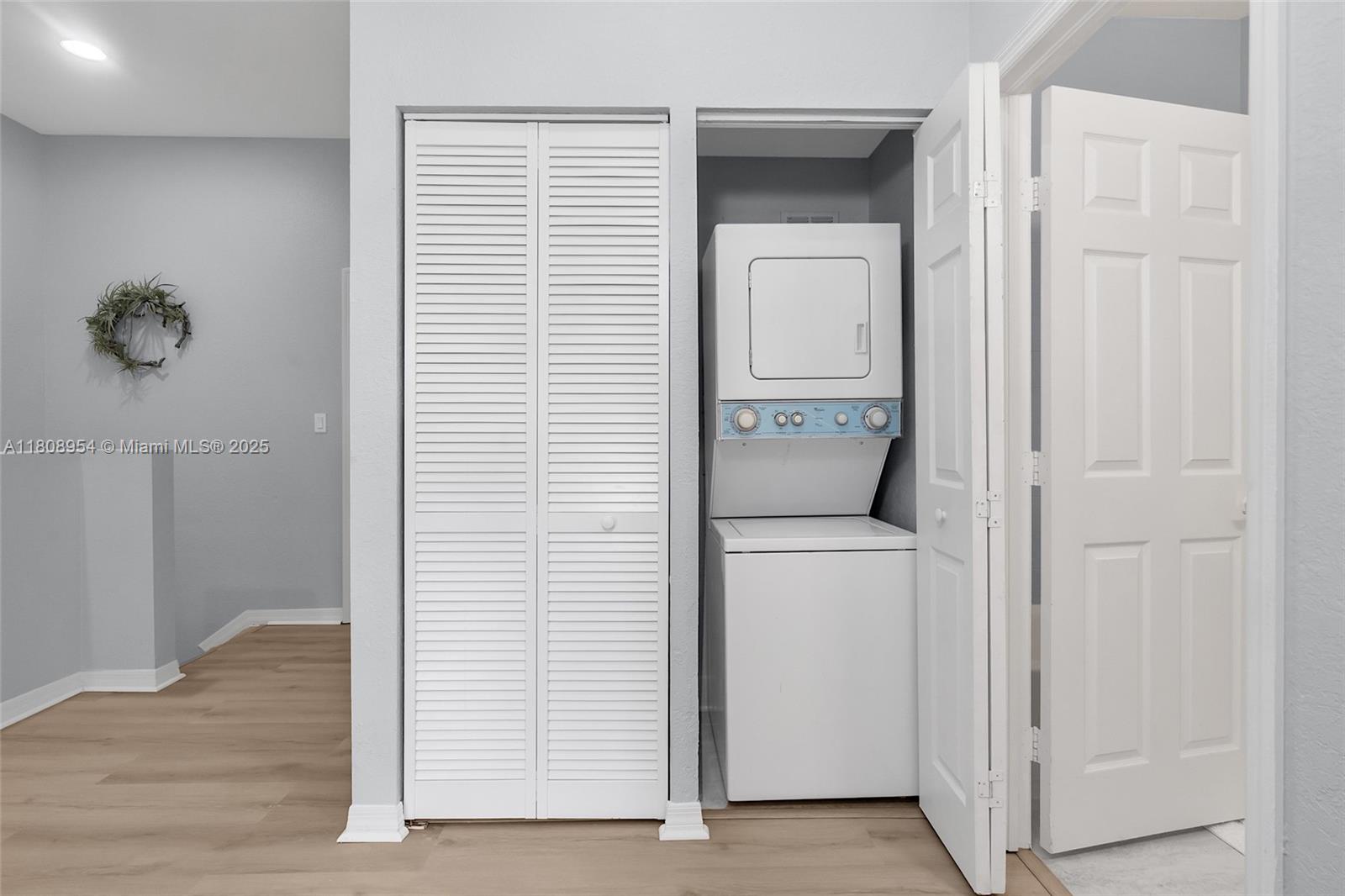 14059 Southwest 49th Street, Unit 4 Miramar, FL 33027 - Photo 19 of 29 a view of washer and dryer with wooden floor