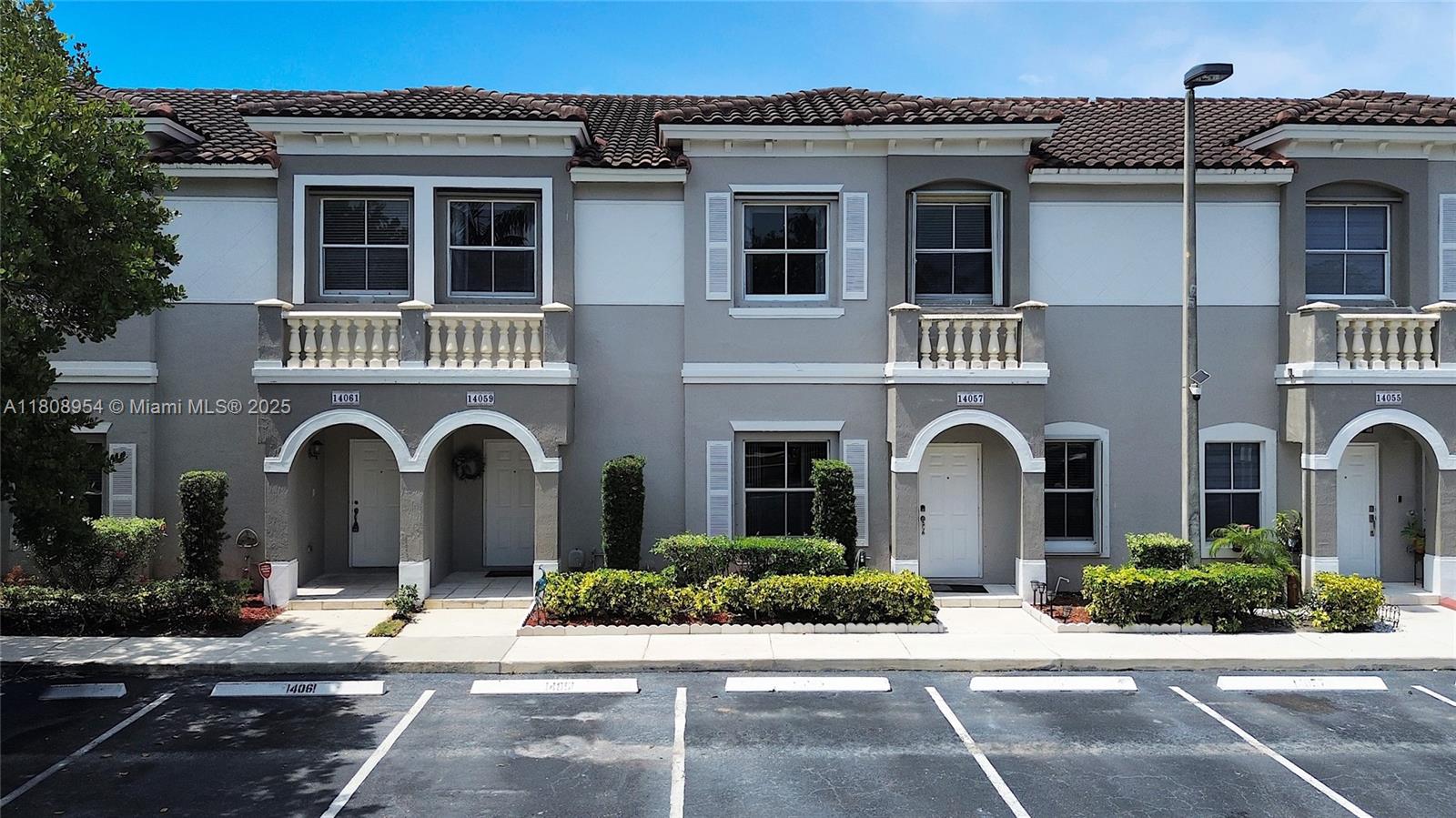 14059 Southwest 49th Street, Unit 4 Miramar, FL 33027 - Photo 2 of 29 a front view of a house with a garden