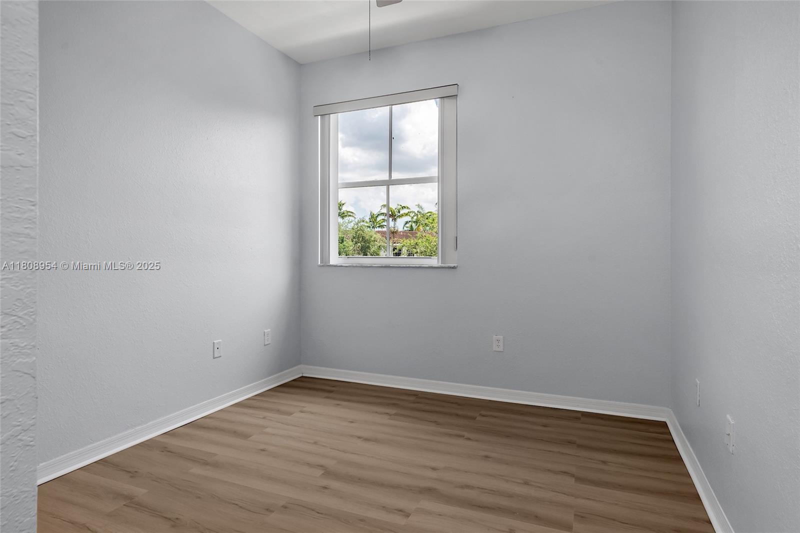 14059 Southwest 49th Street, Unit 4 Miramar, FL 33027 - Photo 23 of 29 wooden floor in an empty room with a window