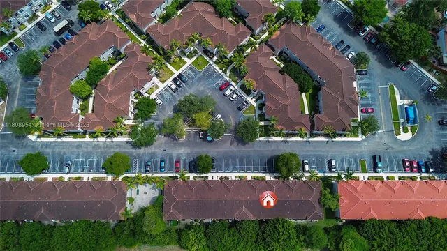 an aerial view of a house with garden space and a swimming pool
