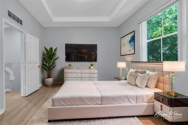 a bedroom with a bed and a flat screen television