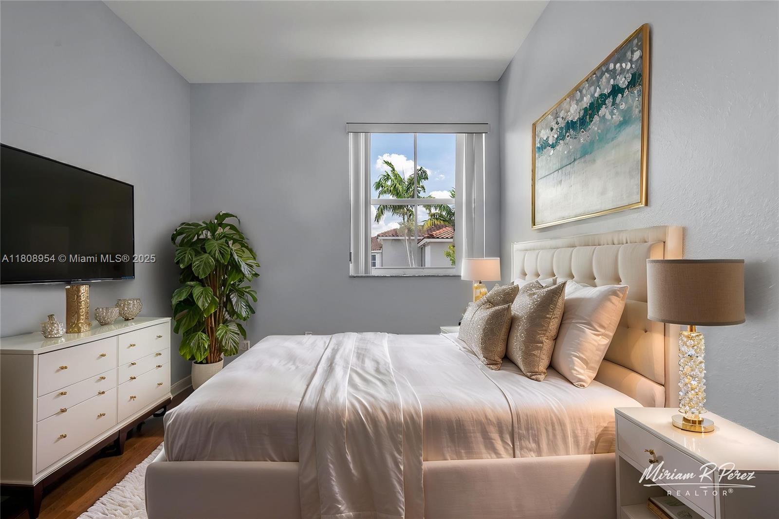 14059 Southwest 49th Street, Unit 4 Miramar, FL 33027 - Photo 6 of 29 a bedroom with a bed and a flat screen tv on the dresser