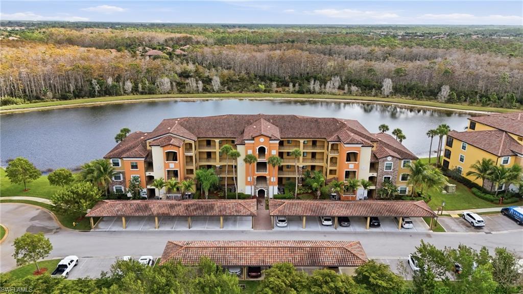 an aerial view of house with yard lake and lake view